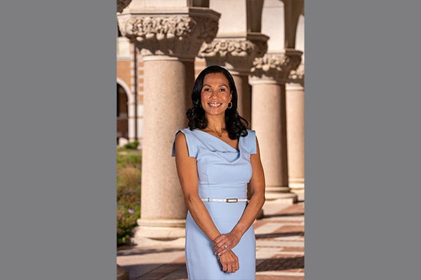 Photo of Paula Gilmer DesRoches wearing a blue dress (vertical)